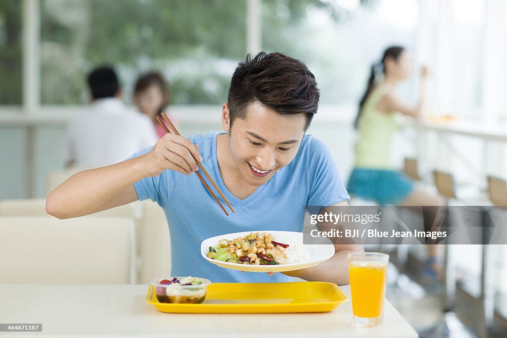 Young man having a meal in restaurant