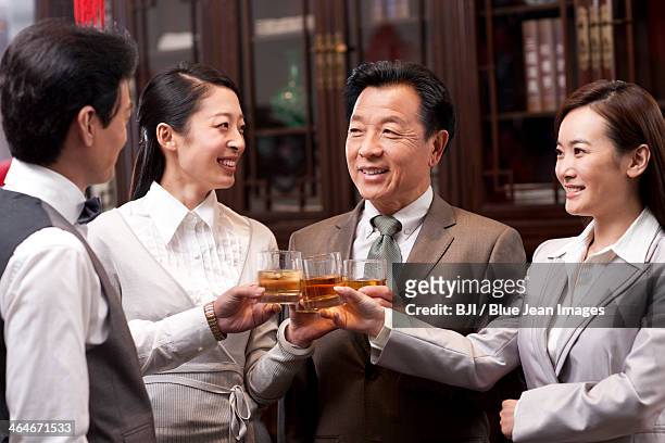 business associates clinking glasses - cognac brandy stock pictures, royalty-free photos & images