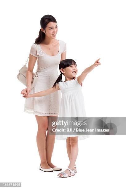 happy young mother and daughter looking at view - tochter zeigt stock-fotos und bilder