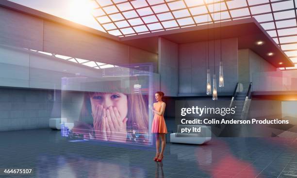 caucasian woman using hologram computer screen - hologramme photos et images de collection