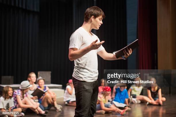 students practicing lines on stage - teenager learning child to read stockfoto's en -beelden