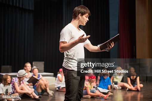 Students practicing lines on stage Students practicing lines on stage