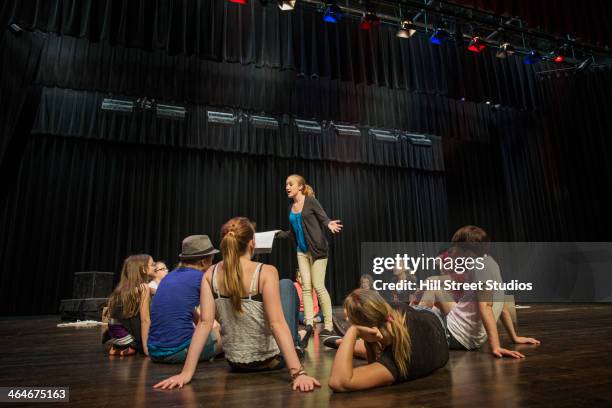 students practicing lines on stage - girl stage stock-fotos und bilder