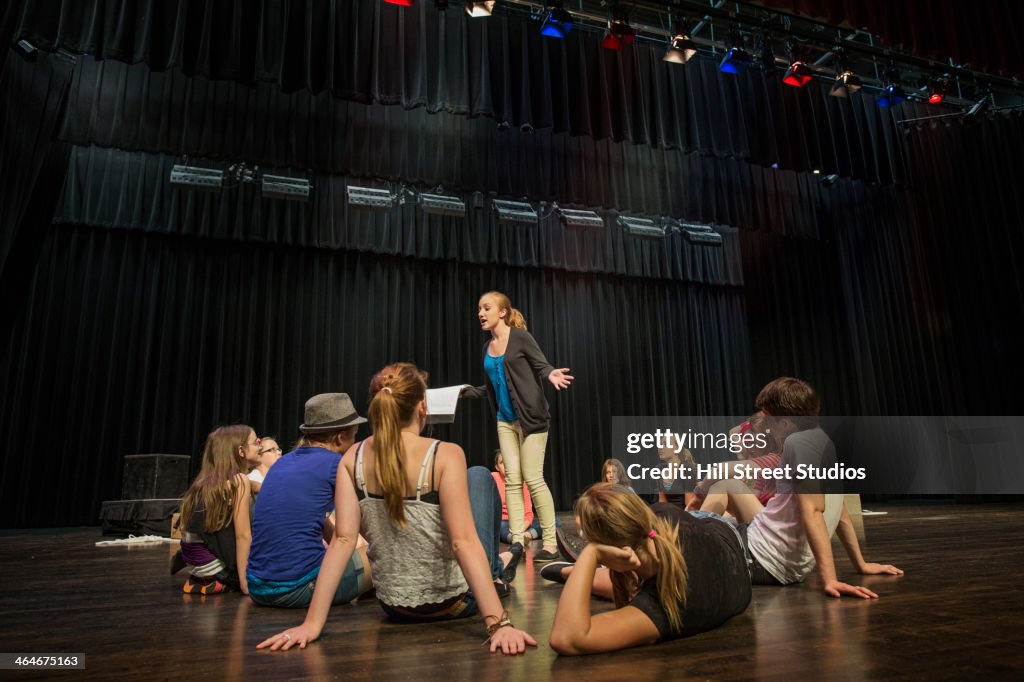 Students practicing lines on stage