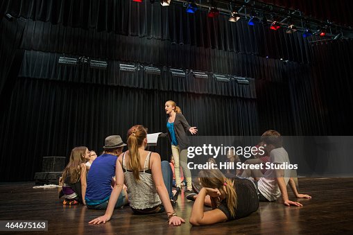 Students practicing lines on stage Students practicing lines on stage