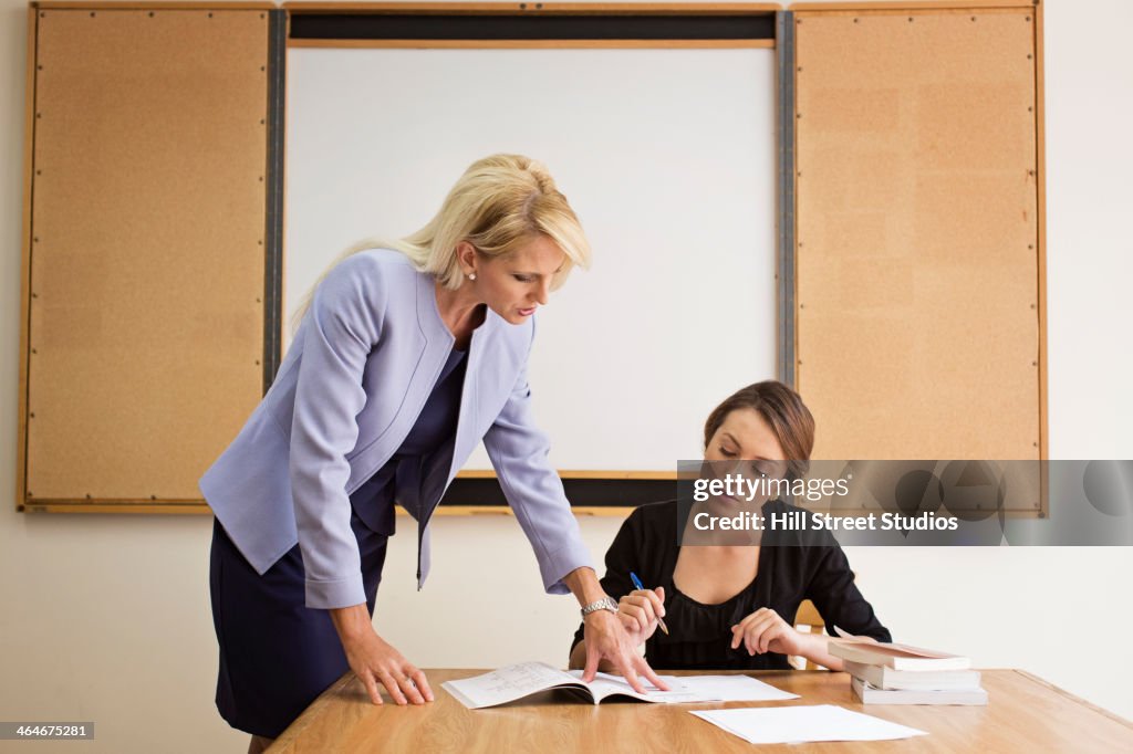 Businesswoman reviewing paperwork in conference room