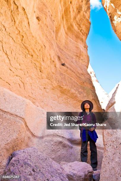 japanese woman exploring rock formations, santa fe, new mexico, united states - santa fe new mexico stock pictures, royalty-free photos & images