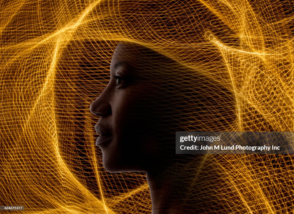 African American woman surrounded by golden netting