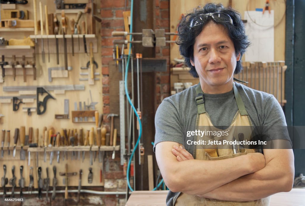 Asian carpenter in workshop