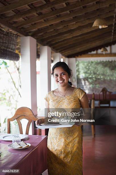 young woman serving dinner at homestay in india - kerala food stock pictures, royalty-free photos & images