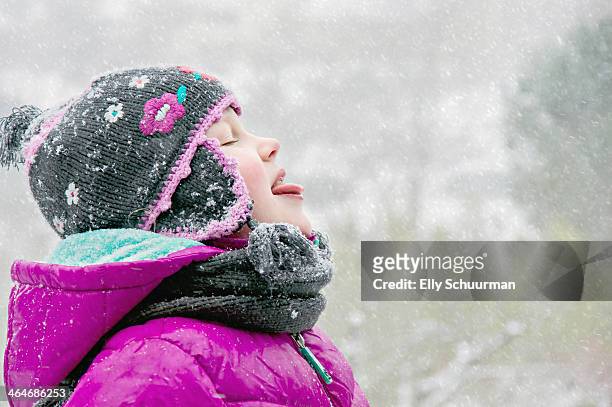 girl in snow - catching snowflakes stock pictures, royalty-free photos & images