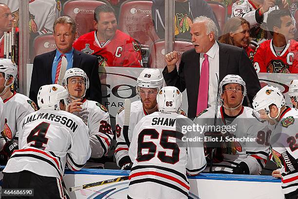 Head Coach Joel Quenneville of the Chicago Blackhawks directs his team from the bench along with Assistant Coach Mike Kitchen against the Florida...