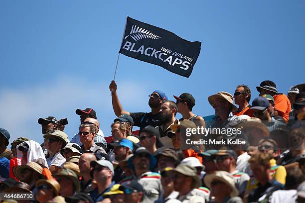 Spectator waves a Blackcaps flag during the national anthem before the 2015 ICC Cricket World Cup match between Australia and New Zealand at Eden...