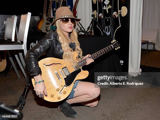 Singer/Songwriter Orianthi performs backstage at the GRAMMYs Westwood One Radio Remotes during the 56th GRAMMY Awards at the Staples Center Arena...