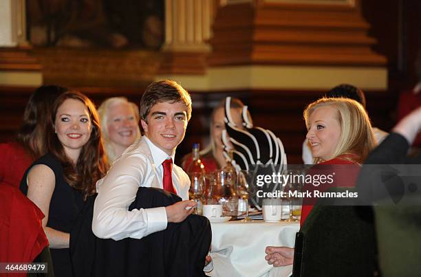 Alpine skiers Jade Etherington, James Whitley and guide Rachel Ferrier of the ParalympicsGB team listens to a speaker during a gala dinner to...