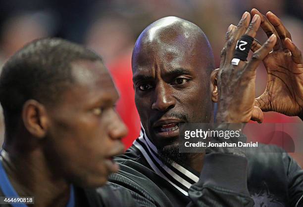 Kevin Garnett of the Minnesota Timberwolves talks with teammate Gorgui Dieng on the bench during a game against the Chicago Bulls at the United...