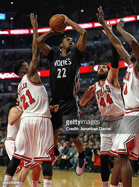 Andrew Wiggins of the Minnesota Timberwolves goes up for a shot over Jimmy Butler, Nikola Mirotic and Nazr Mohammed of the Chicago Bulls at the...