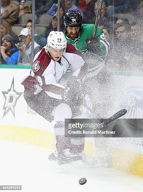Nathan MacKinnon of the Colorado Avalanche skates the puck against Jordie Benn of the Dallas Stars in the second period at American Airlines Center...
