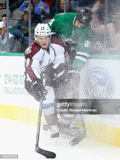 Nathan MacKinnon of the Colorado Avalanche skates the puck against Jordie Benn of the Dallas Stars in the second period at American Airlines Center...