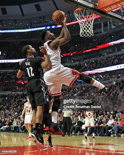 Jimmy Butler of the Chicago Bulls puts up a shot over Gary Neal of the Minnesota Timberwolves on his way to a game-high 28 points at the United...