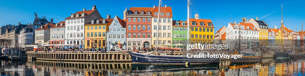 Copenhagen crowded Nyhavn colorful bars restaurants panorama beside harbour Denmark