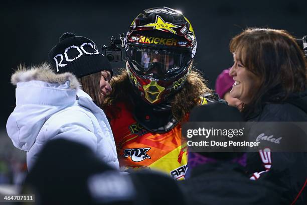 Colten Moore talks with his girlfriend Ashley Hammons and his mother Michele Moore after his first run in the snowmobile freestyle finals at Winter...