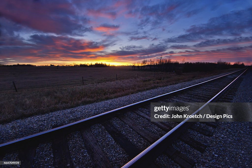 Train Tracks And A Dramatic Colourful Sky At Sunset