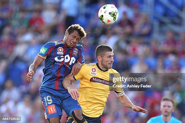 Nick Montgomery of the Mariners contests the header against Mitch Cooper of the Jets during the round 19 A-League match between the Newcastle Jets...