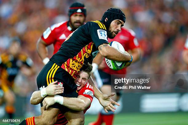 Charlie Ngatai of the Chiefs is tackled by Colin Slade of the Crusaders during the round three Super Rugby match between the Chiefs and the Crusaders...
