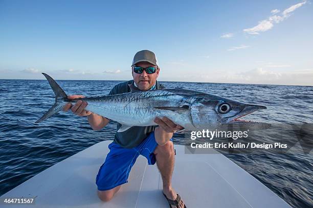 man holding a large fresh caught fish - catch of fish stock pictures, royalty-free photos & images