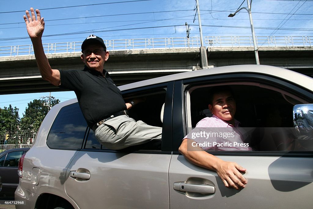 Former Philippine president Fidel Ramos waves to the crowd...