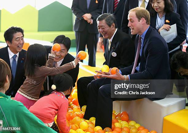 Prince William, Duke of Cambridge and Japanese Prime Minister Shinzo Abe play with children as they visit Smile Kid's Park on February 28, 2015 in...