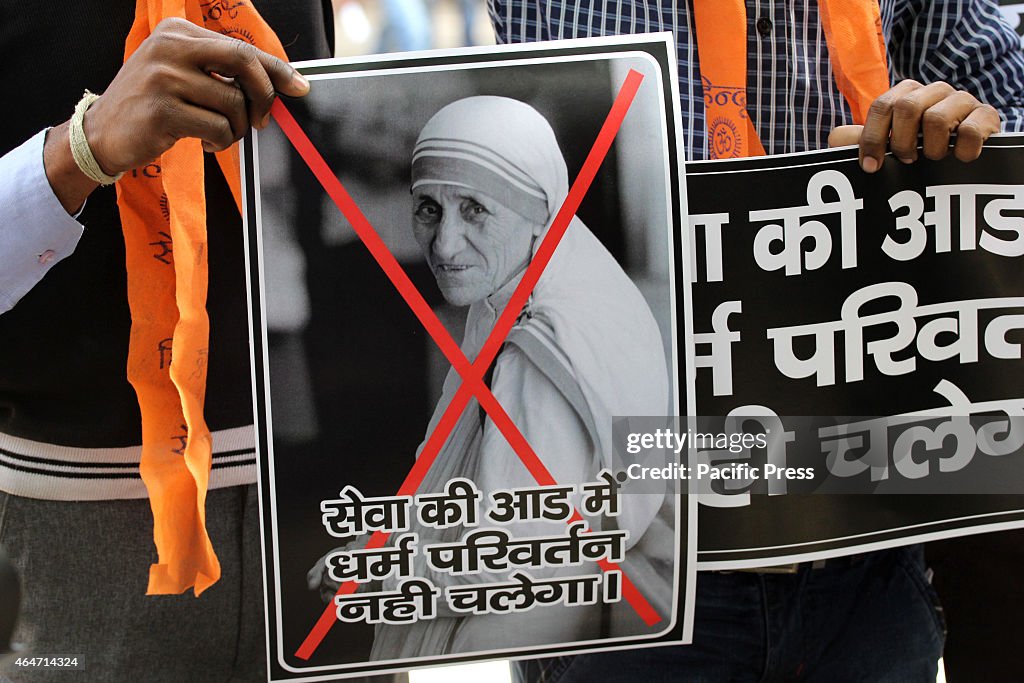 A Hindu Sena Activist bringing a poster of Mother Teresa...