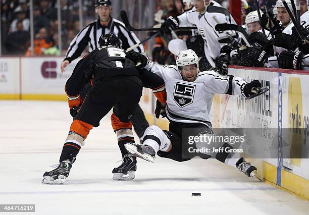 Jarret Stoll of the Los Angeles Kings is checked into the boards by Ben Lovejoy of the Anaheim Ducks in the second period at Honda Center on January...