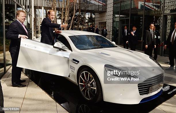 Prince William, Duke of and Mark Palmer, CEO of Aston Martin, pose with an Aston Martin Rapide S during a visit to the British designed Tsutaya...