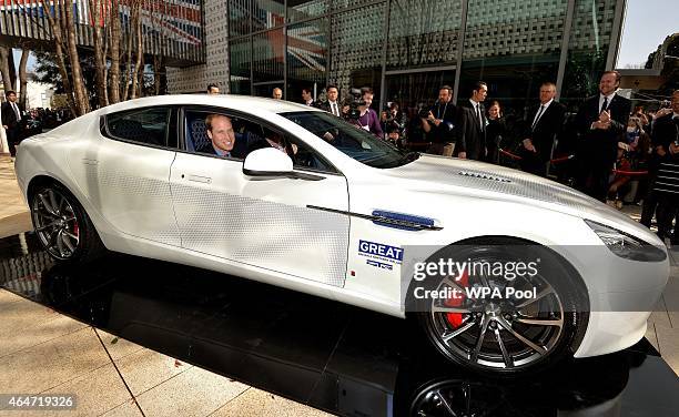 Prince William, Duke of Cambridge sits in an Aston Martin Rapide S during his visit to the British designed Tsutaya bookshop on February 28, 2015 in...