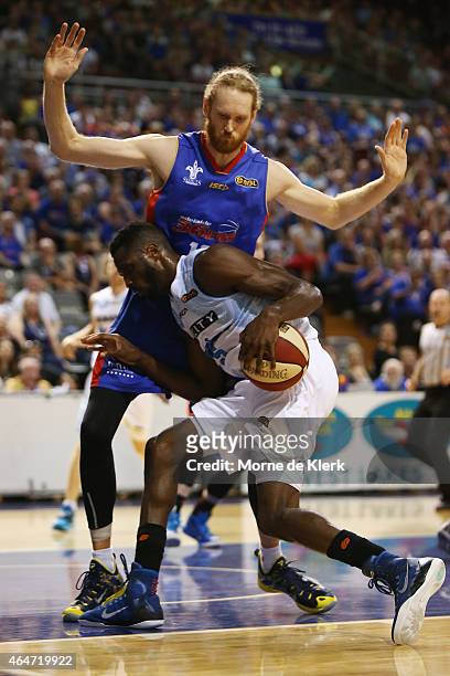 Luke Schenscher of the 36ers block Ekene Ibekwe of the Breakers during game two of the NBL Finals series between the New Zealand Breakers and the...