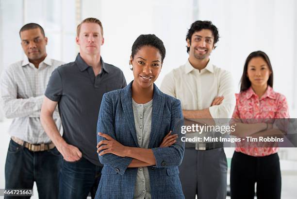 an office in the city. business. a team of people, a multi ethnic group, men and women standing together in a group. - indian woman short hair stock pictures, royalty-free photos & images