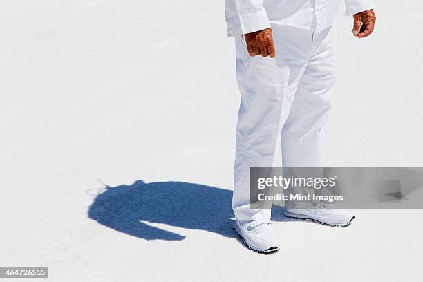 a man in white overalls,a race official timekeeper at a car racing event, at speed week on bonneville salt flats. - white jumpsuit stock pictures, royalty-free photos & images