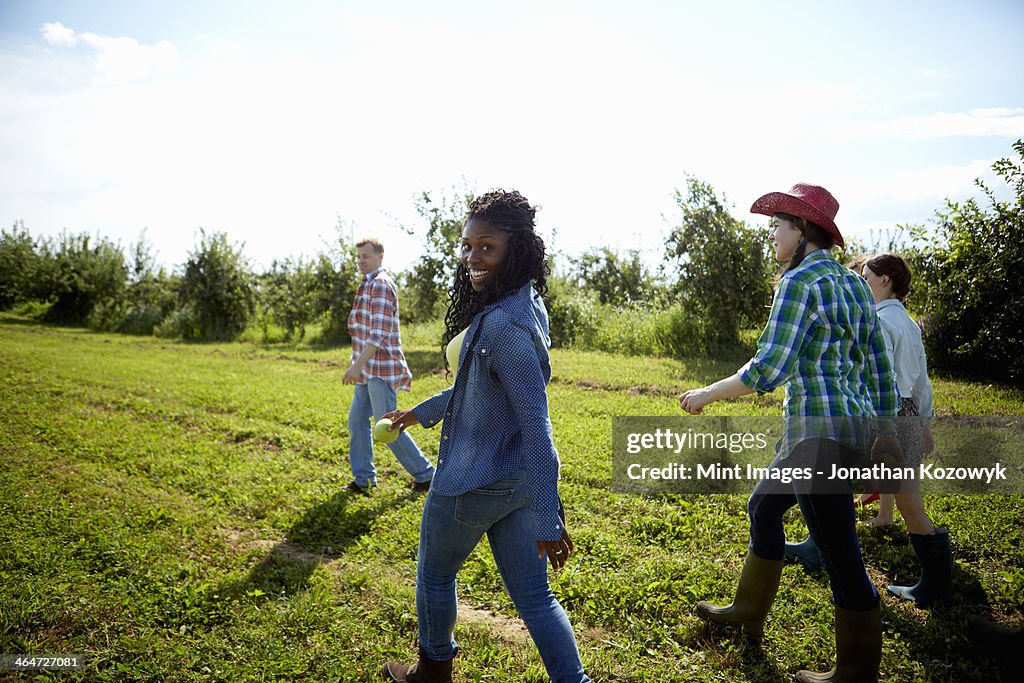 A group of young men and women in the fields of an organic farm.
