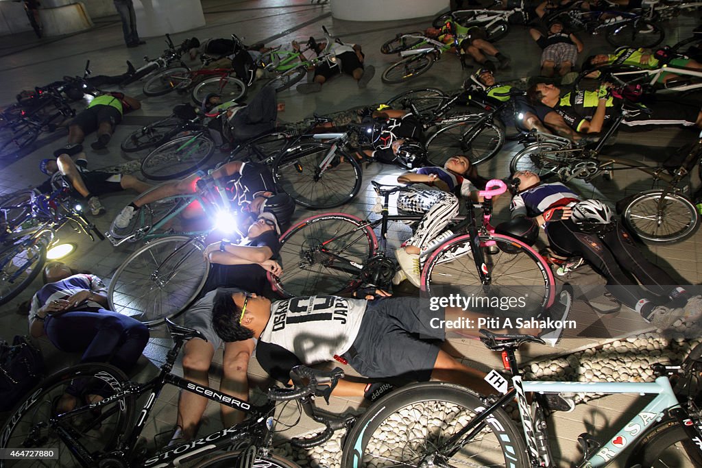 Group of Thai cyclists planking with their bicycles during a...