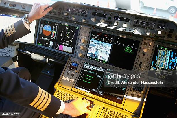 Pilote on the flight deck in the new Airbus A350X WB passenger plane as he stands on the tarmac at Munich Airport during a presentation of the new...