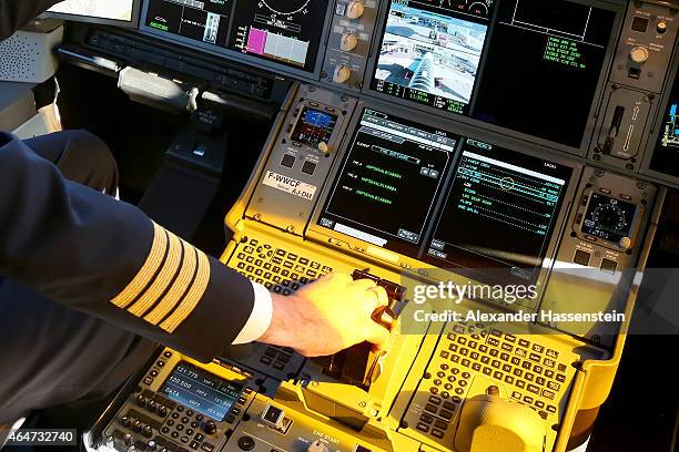 Pilote on the flight deck in the new Airbus A350X WB passenger plane as he stands on the tarmac at Munich Airport during a presentation of the new...
