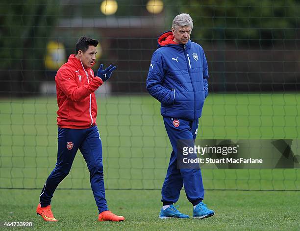 Arsenal manager Arsene Wenger with Alexis Sanchez before a training session at London Colney on February 28, 2015 in St Albans, England.