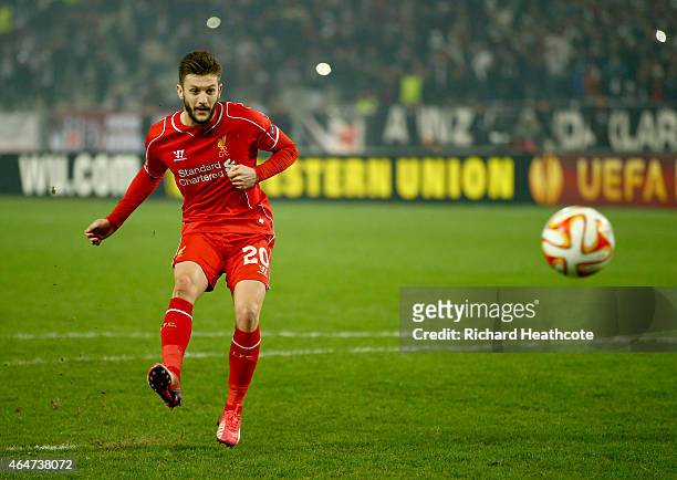 Adam Lallana of Liverpool scores his penalty in the shoot out during the 2nd leg of the UEFA Europa League Round of 32 match between Besiktas and...