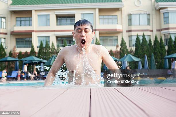 man with eyes closed and mouth open exiting the pool - gå i land bildbanksfoton och bilder