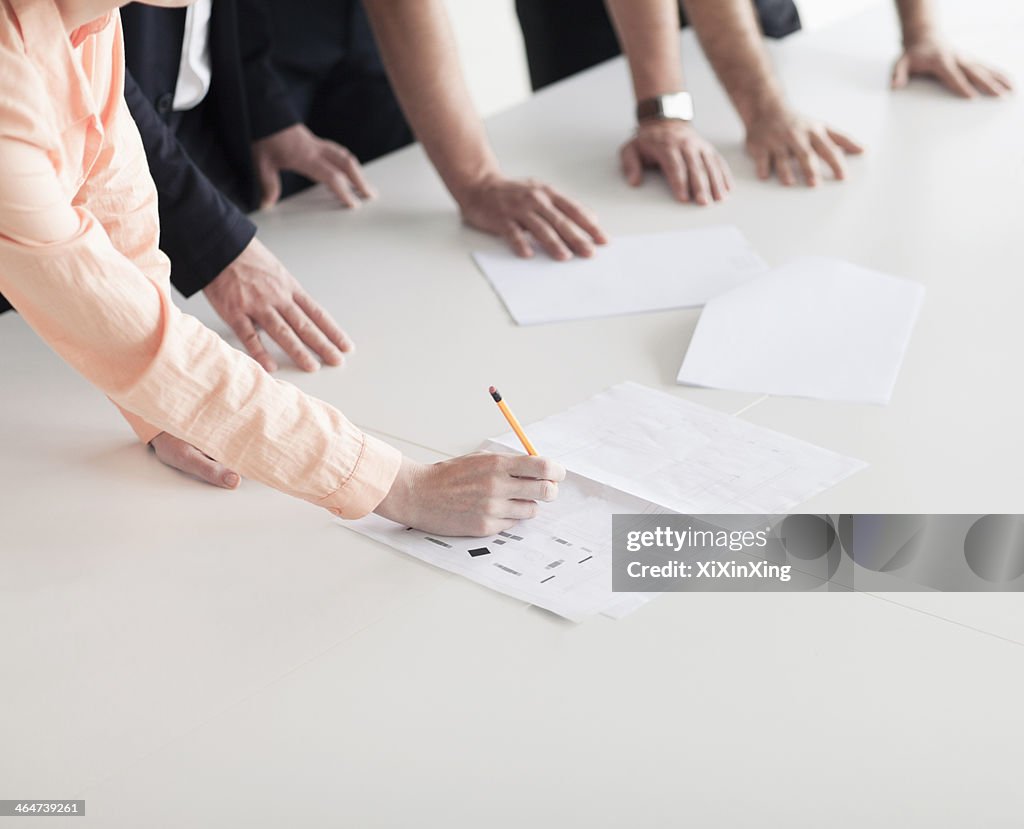 Close up of arms and hands of business people in the office having a business meeting
