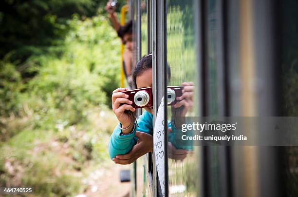 tourist photographing through train window, shimla, himachal pradesh, india - shimla stock pictures, royalty-free photos & images