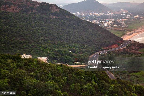 aerial view of road passing through mountains, visakhapatnam, andhra pradesh, india - kailasagiri park stock pictures, royalty-free photos & images