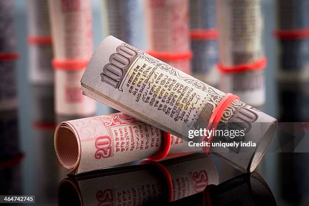 close-up of rolled-up indian paper currency - indian rupee note stock pictures, royalty-free photos & images